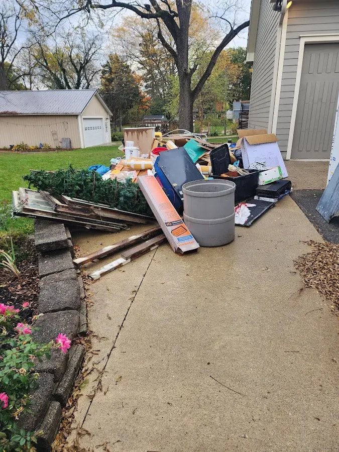 Dumpster being loaded with debris for 12 Yard Dumpster Rental in Granby